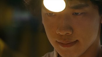 Movie still from “I'm a Cyborg, But That's OK” (2006), directed by Park Chan-wook – A person's face with a light shining on it; Extreme Close Up shot, High angle