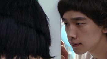 Movie still from “I'm a Cyborg, But That's OK” (2006), directed by Park Chan-wook – A man and a woman looking at one another; Close Up shot, Over the shoulder angle