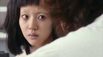 Movie still from “I'm a Cyborg, But That's OK” (2006), directed by Park Chan-wook – A person looking at a mirror; Close Up shot, Over the shoulder angle