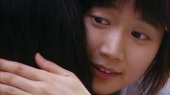 Movie still from “I'm a Cyborg, But That's OK” (2006), directed by Park Chan-wook – A young woman's face with her hand on her face; Extreme Close Up shot, Over the shoulder angle