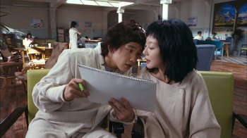 Movie still from “I'm a Cyborg, But That's OK” (2006), directed by Park Chan-wook – A man and a woman are looking at a notebook; Close Up shot, Over the shoulder angle