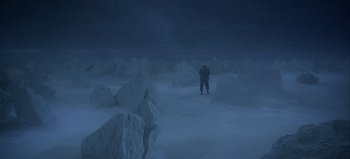 Movie still from “Ice Station Zebra” (1968), directed by John Sturges – A man standing in the middle of a snowy field; Extreme Wide shot, High angle