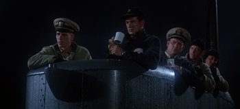 Movie still from “Ice Station Zebra” (1968), directed by John Sturges – A group of men standing next to each other on a dock; Medium shot, Low angle