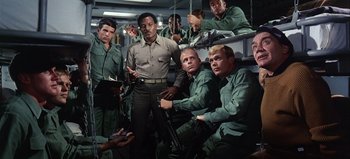 Movie still from “Ice Station Zebra” (1968), directed by John Sturges – A group of men in green fatigues holding guns; Medium shot, High angle