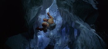 Movie still from “Ice Station Zebra” (1968), directed by John Sturges – A man is climbing up the side of a cave; Wide shot, Overhead angle
