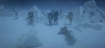 Movie still from “Ice Station Zebra” (1968), directed by John Sturges – A group of people are walking through the snow; Extreme Wide shot, High angle