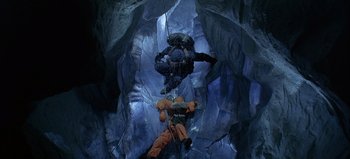 Movie still from “Ice Station Zebra” (1968), directed by John Sturges – Two people are hanging from ropes in an ice cave; Wide shot, Overhead angle