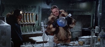 Movie still from “Ice Station Zebra” (1968), directed by John Sturges – A man in a fur coat holding a glass; Medium shot, Low angle