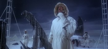 Movie still from “Ice Station Zebra” (1968), directed by John Sturges – A man in a white parka standing in the snow; Medium shot, Low angle