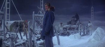 Movie still from “Ice Station Zebra” (1968), directed by John Sturges – A man standing in the middle of a snow covered field; Wide shot, Low angle