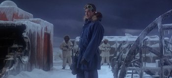 Movie still from “Ice Station Zebra” (1968), directed by John Sturges – A man standing in the middle of a snowy field; Medium shot, Low angle