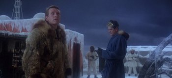 Movie still from “Ice Station Zebra” (1968), directed by John Sturges – Two men dressed in winter clothing and one is wearing a fur coat; Medium shot, Low angle