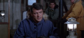 Movie still from “Ice Station Zebra” (1968), directed by John Sturges – A man wearing a blue parka with a furry hood; Close Up shot, Over the shoulder angle