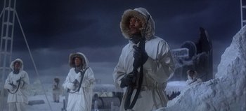 Movie still from “Ice Station Zebra” (1968), directed by John Sturges – A man in a white parka and a woman in a white parka; Medium shot, Low angle