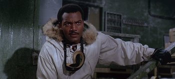 Movie still from “Ice Station Zebra” (1968), directed by John Sturges – A man wearing a white parka with a furry hood; Close Up shot, Low angle