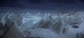 Movie still from “Ice Station Zebra” (1968), directed by John Sturges – A man standing on top of a pile of rocks; Extreme Wide shot, High angle
