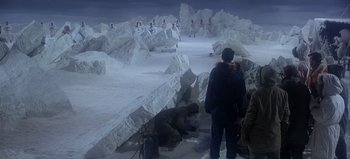 Movie still from “Ice Station Zebra” (1968), directed by John Sturges – A group of people standing in the middle of an ice cave; Extreme Wide shot, High angle