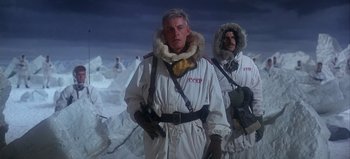 Movie still from “Ice Station Zebra” (1968), directed by John Sturges – A man in a white jacket and a man in a black jacket; Medium shot, Low angle