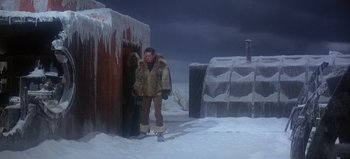 Movie still from “Ice Station Zebra” (1968), directed by John Sturges – A man standing in front of an ice house; Wide shot, High angle
