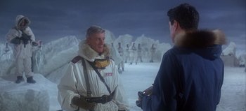 Movie still from “Ice Station Zebra” (1968), directed by John Sturges – A man in a white jacket talking to another man in a white jacket; Medium shot, Over the shoulder angle