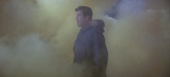 Movie still from “Ice Station Zebra” (1968), directed by John Sturges – A man in a hooded jacket standing in a cloud of smoke; Medium shot, Low angle