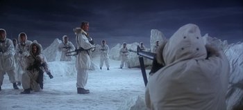 Movie still from “Ice Station Zebra” (1968), directed by John Sturges – A group of men in snow suits holding guns in their hands; Wide shot, Low angle