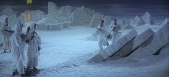 Movie still from “Ice Station Zebra” (1968), directed by John Sturges – Two men in white suits are walking through the snow; Wide shot, High angle