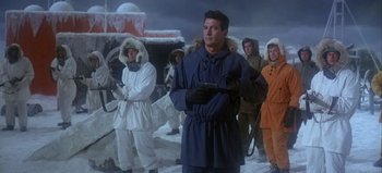 Movie still from “Ice Station Zebra” (1968), directed by John Sturges – A group of people in winter clothing standing in the snow; Medium shot, Low angle