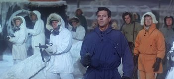 Movie still from “Ice Station Zebra” (1968), directed by John Sturges – A group of men in winter coats standing next to each other; Medium shot, Low angle