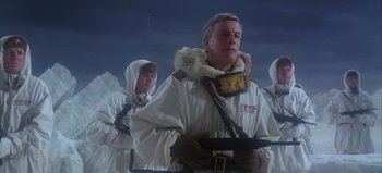 Movie still from “Ice Station Zebra” (1968), directed by John Sturges – A group of men in white jackets holding guns; Medium shot, Low angle