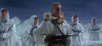 Movie still from “Ice Station Zebra” (1968), directed by John Sturges – A group of men in white coats standing next to each other in the snow; Medium shot, Low angle