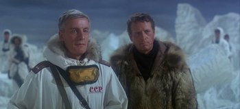 Movie still from “Ice Station Zebra” (1968), directed by John Sturges – Two men standing next to each other wearing jackets; Medium shot, Low angle