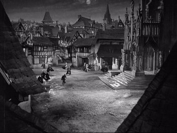 Movie still from “If I Were King” (1938), directed by Frank Lloyd – A black - and - white photo of a medieval town; Extreme Wide shot, High angle