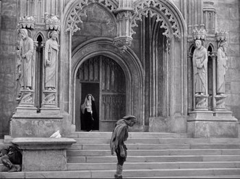 Movie still from “If I Were King” (1938), directed by Frank Lloyd – A man walking down the steps in front of a building; Wide shot, Low angle
