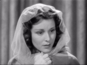 Movie still from “If I Were King” (1938), directed by Frank Lloyd – A black - and - white photo of a woman wearing a veil; Close Up shot, High angle