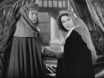 Movie still from “If I Were King” (1938), directed by Frank Lloyd – A man and a woman are shaking hands; Medium shot, High angle