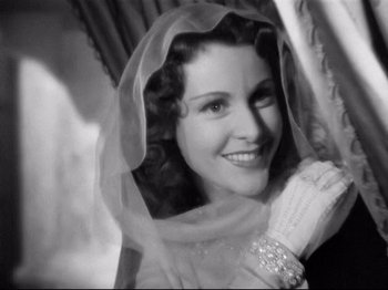 Movie still from “If I Were King” (1938), directed by Frank Lloyd – A black - and - white photo of a woman wearing a veil; Close Up shot, Low angle