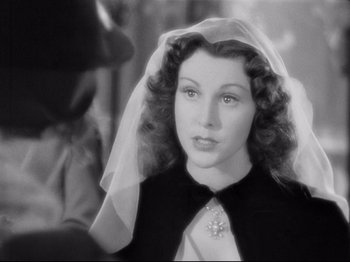 Movie still from “If I Were King” (1938), directed by Frank Lloyd – A black - and - white photo of a woman wearing a wedding veil; Close Up shot, Over the shoulder angle