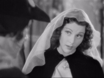 Movie still from “If I Were King” (1938), directed by Frank Lloyd – A black - and - white photo of a woman with a veil; Close Up shot, Over the shoulder angle