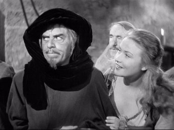 Movie still from “If I Were King” (1938), directed by Frank Lloyd – A black and white photo of a man and two women; Close Up shot, Over the shoulder angle