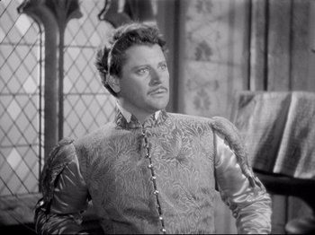 Movie still from “If I Were King” (1938), directed by Frank Lloyd – A black and white photo of a man wearing a suit; Medium shot, High angle