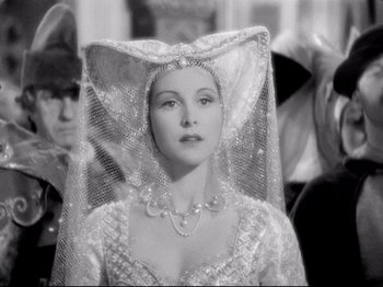 Movie still from “If I Were King” (1938), directed by Frank Lloyd – A black and white photo of a woman wearing a veil; Close Up shot, Over the shoulder angle