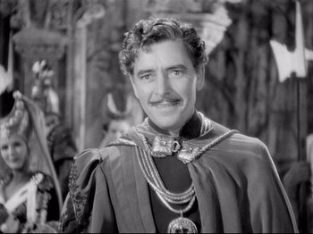 Movie still from “If I Were King” (1938), directed by Frank Lloyd – A black and white photo of a man wearing a crown; Medium shot, Over the shoulder angle