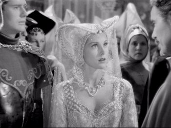 Movie still from “If I Were King” (1938), directed by Frank Lloyd – A black and white photo of a woman in a medieval costume; Close Up shot, Over the shoulder angle