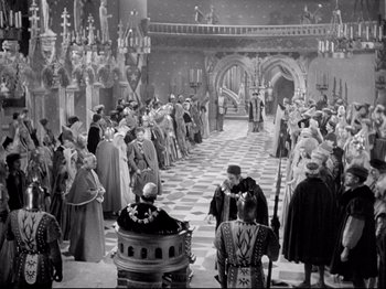 Movie still from “If I Were King” (1938), directed by Frank Lloyd – A black and white photo of a crowd of people in medieval garb; Extreme Wide shot, High angle
