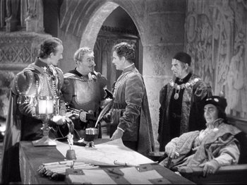 Movie still from “If I Were King” (1938), directed by Frank Lloyd – A black and white photo of a group of men in medieval garb; Medium shot, High angle