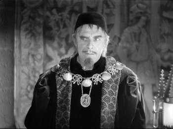 Movie still from “If I Were King” (1938), directed by Frank Lloyd – A black and white photo of a man wearing a crown; Medium shot, High angle