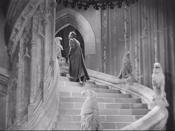 Movie still from “If I Were King” (1938), directed by Frank Lloyd – An old photo of a man walking down a set of stairs; Wide shot, High angle