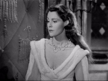 Movie still from “If I Were King” (1938), directed by Frank Lloyd – A black - and - white photo of a woman wearing a dress; Close Up shot, Over the shoulder angle