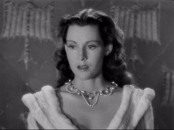 Movie still from “If I Were King” (1938), directed by Frank Lloyd – A black - and - white photo of a woman wearing a pearl necklace; Close Up shot, Low angle